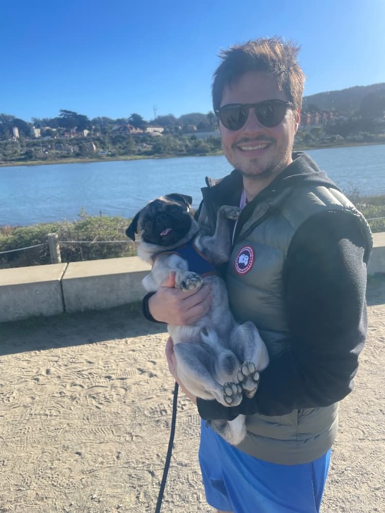 Eric with his pug Rafa on a sunny day in the Bay Area